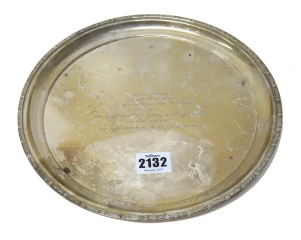 A silver circular salver, having a decorated border, presentation inscribed to the centre, diameter 24.5cm, weight 467 gms.   Part 54.