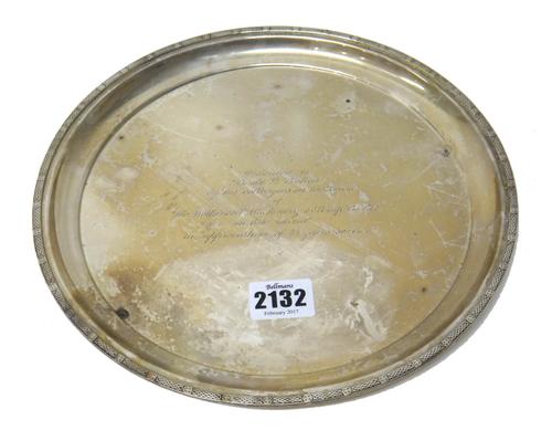 A silver circular salver, having a decorated border, presentation inscribed to the centre, diameter 24.5cm, weight 467 gms.   Part 54.