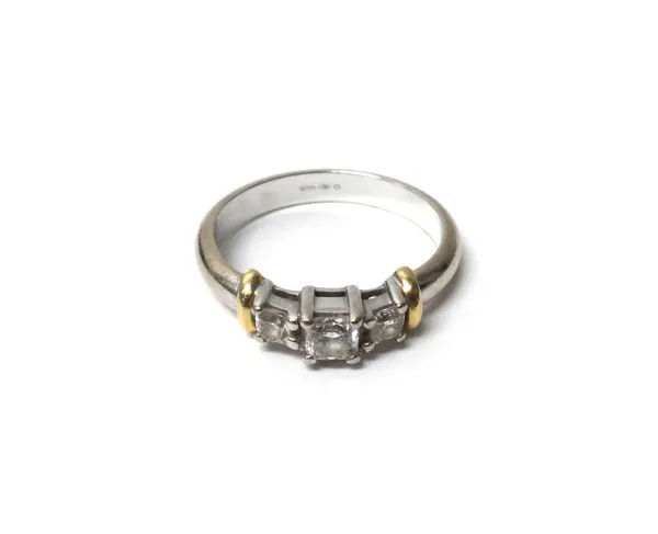 A white gold and diamond set three stone ring, claw set with the principal square cut diamond at the centre, between two smaller square cut diamonds,