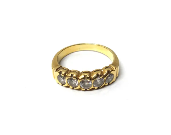 A gold and diamond set five stone ring, mounted with a row of circular cut diamonds, detailed 750, ring size U, with a case.