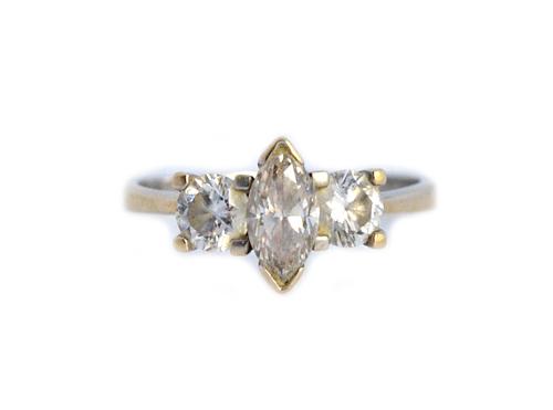 A white gold and diamond set three stone ring, claw set with the marquise shaped diamond at the centre, between two circular cut diamonds, detailed 75