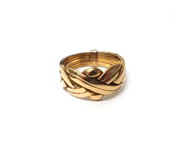 A gold puzzle ring in a multiple section design bound at the back detailed 750, weight 9 gms, ring size P.