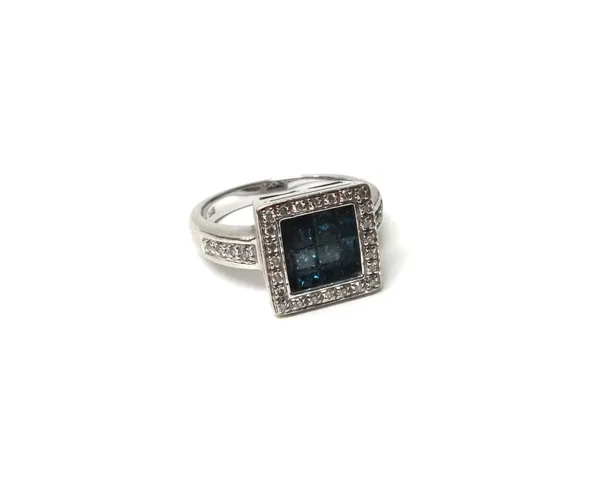 A white gold, diamond and treated blue diamond set square shaped cluster ring, the recessed centre mounted with square cut treated blue diamonds, with