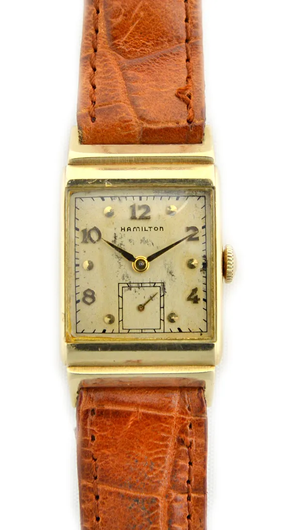 A Hamilton gold rectangular cased gentleman's wristwatch, the signed silvered dial with alternating gilt Arabic and dot numerals, with gilt hands and