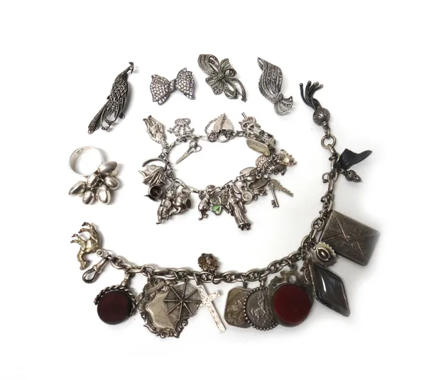 A silver charm bracelet, fitted with a variety of mostly silver charms, with a heart shaped padlock clasp, an anchor link bracelet, fitted with a vari