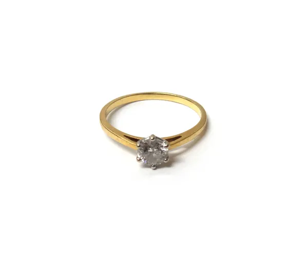 A gold and diamond set single stone ring, claw set with a circular cut diamond detailed 18 CT, ring size U, with a case.