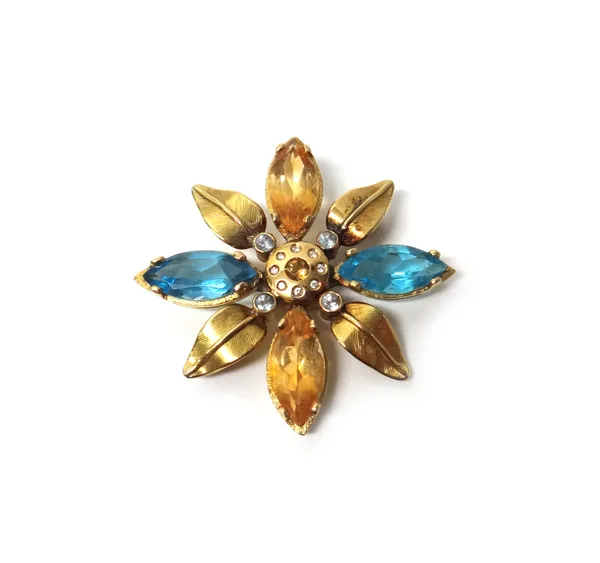 A gold, diamond, citrine and pale blue gem set pendant brooch, designed as a stylized flowerhead, with foliate divisions at intervals.