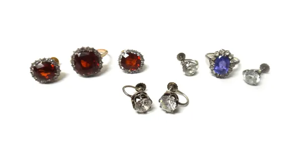 A lilac sapphire and colourless gem set oval cluster ring, a hessonite garnet and colourless gem set cluster ring, a pair of hessonite garnet and colo