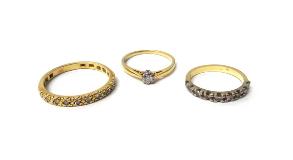 An 18ct gold and diamond set single stone ring, claw set with a circular cut diamond, a gold and diamond set nine stone half hoop eternity ring, mount