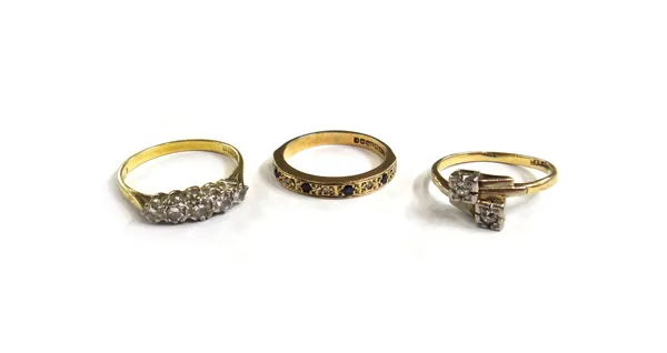 An 18ct gold and diamond set five stone ring, claw set with a row of circular cut diamonds graduating in size to the centre stone, a gold and platinum