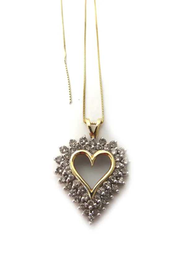 A gold and diamond set pendant, pierced in an openwork heart shaped design, mounted with two rows of circular cut diamonds, detailed 10 K, on a gold n