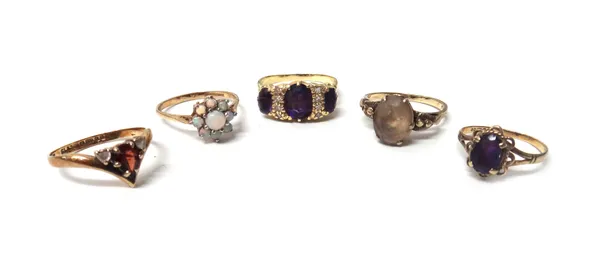 A gold, amethyst and diamond ring, claw set with three oval cut amethysts and with two diamond set four stone divisions at intervals, a 9ct gold and o