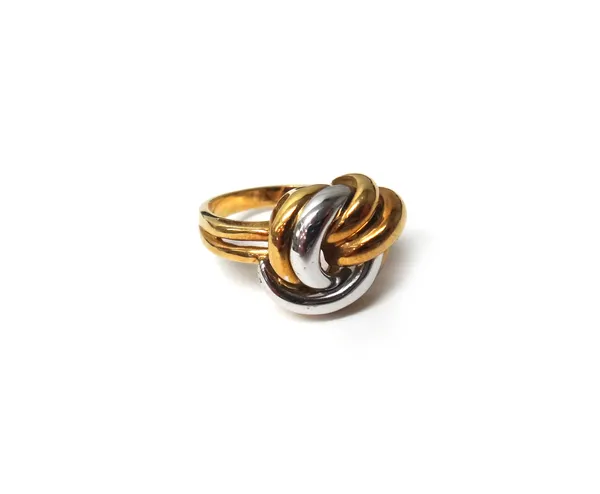 An 18ct two colour gold ring, in an interwoven knot shaped design, ring size M, weight 8.2 gms.