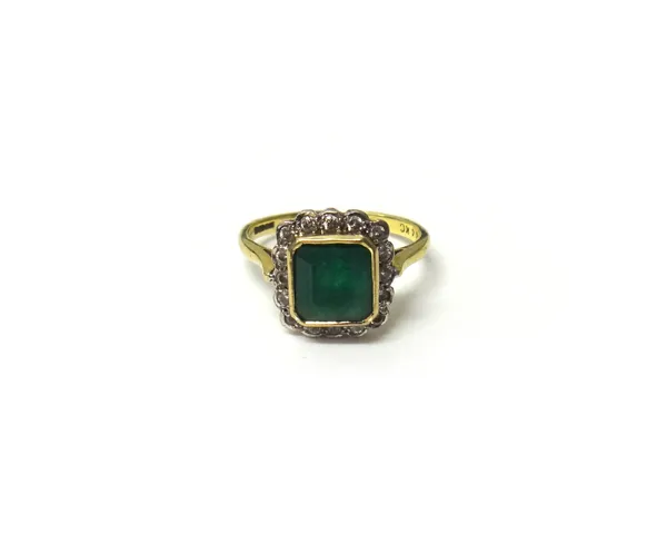 An 18ct gold, emerald and diamond square cluster ring, mounted with the cut cornered square cut emerald within a surround of circular cut diamonds, ri