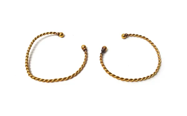 Two gold torque style bangles, each of ropetwist wirework form, having spherical terminals, combined weight 12 gms, with a case, (2).