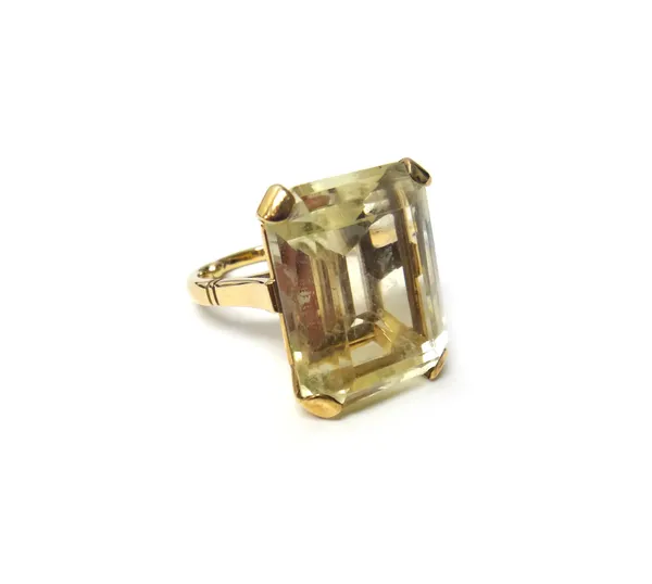 A gold ring, claw set with a cut cornered rectangular step cut pale citrine, ring size N, (note: arthritic bobbles to the shank), with a case.