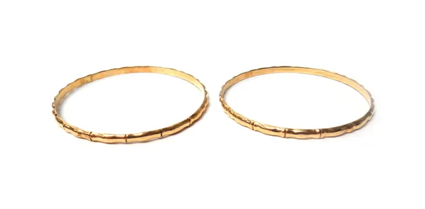 Two gold circular bangles, each in a simulated bamboo design, unmarked, combined weight 15.6 gms, with a case, (2).