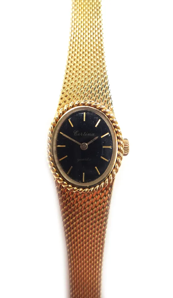 A lady's 9ct gold Certina Quartz bracelet wristwatch, the signed oval black dial with gilt baton shaped numerals on a tapering woven link bracelet wit
