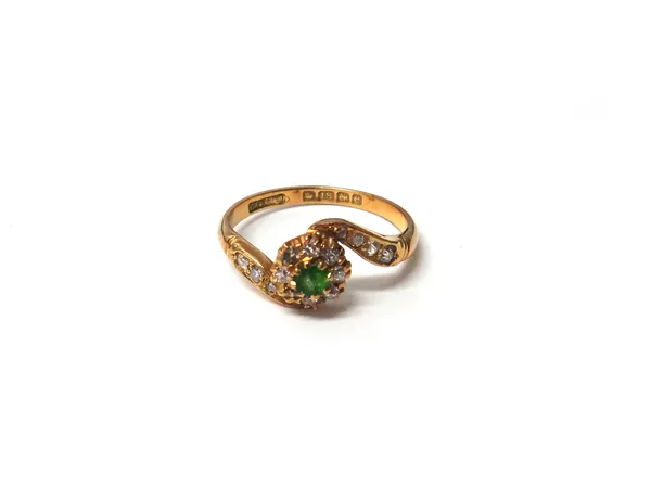 An 18ct gold, demantoid garnet and diamond set cluster ring, mounted with the demantoid garnet (very rubbed) at the centre, in a surround of cushion s