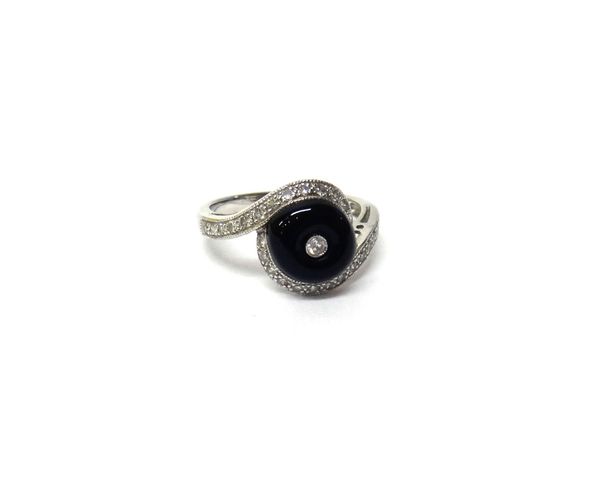 A white gold, diamond and black onyx set ring, mounted with the principle circular cut diamond at the centre, on a black onyx ground, between diamond