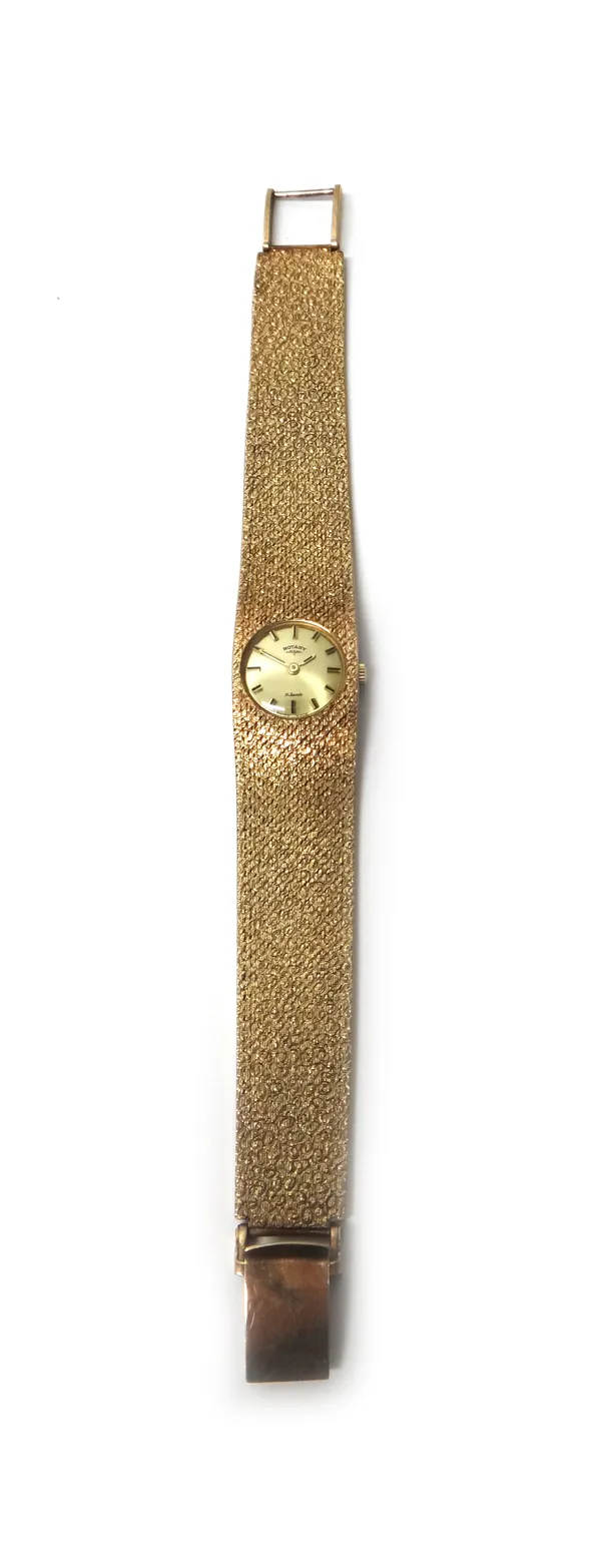 A lady's 9ct gold Rotary bracelet wristwatch, the signed circular gilt dial with black baton shaped numerals, on a textured tapering woven mesh link b