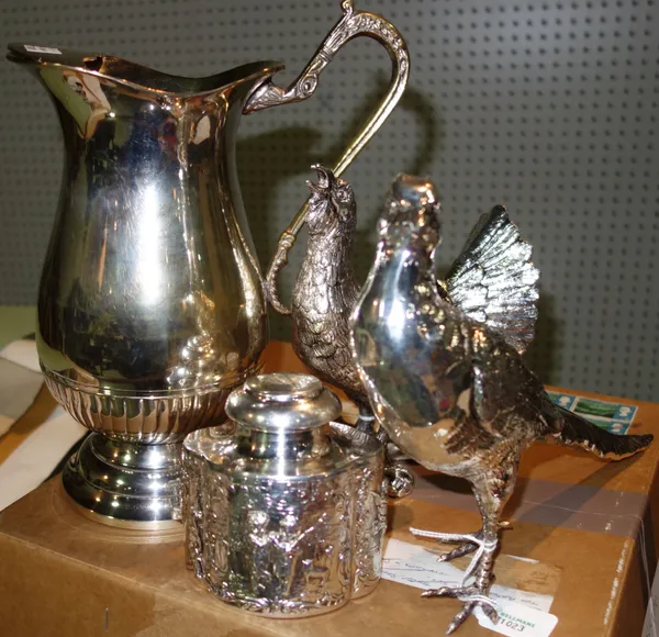 A silver plated lemonade jug of baluster form, together with two silver plated models of game birds and a plated tea caddy, with embossed decoration.