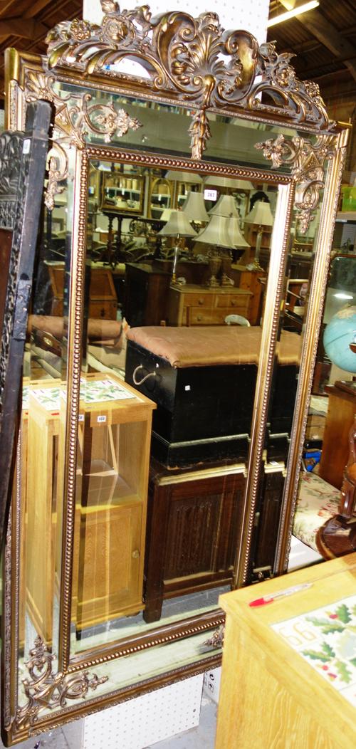 A 20th century brass standard lamp with trefoil base and an adjustable standard lamp. (2)  H4