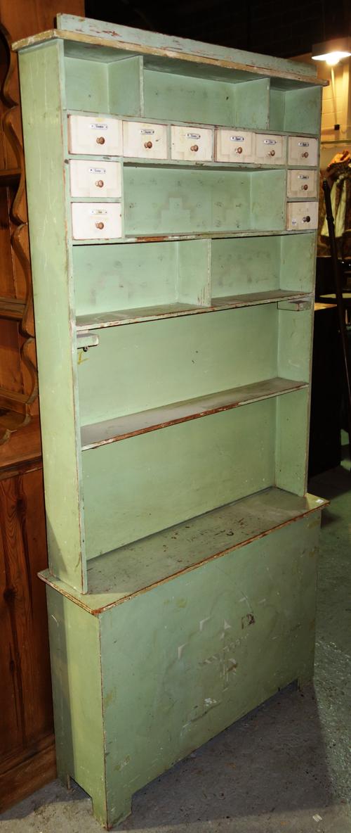A green painted child's shop front in two sections, 85cm wide x 177cm high. K6