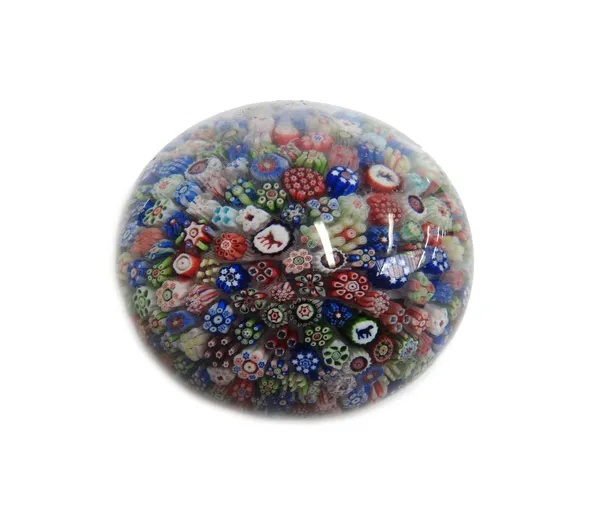 A Baccarat close-packed millefiori paperweight, dated 1848, inset with brightly coloured canes and silhouette canes including a horse and dog and the