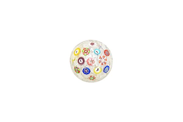 A Baccarat spaced millefiori glass paperweight, dated 1848, set with evenly spaced canes on an upset muslin ground, the canes including silhouette can