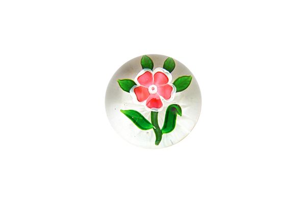 A Baccarat dogrose paperweight, mid-19th century, with five heart shaped red petals edged in white, the stalk with six leaves, star-cut base, two chip