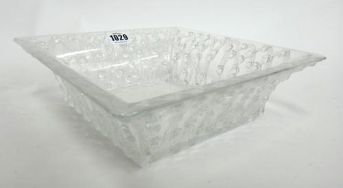 A Lalique clear and frosted glass bowl, of everted square form, moulded with floral wreaths and etched Lalique France, 24.5cm wide.