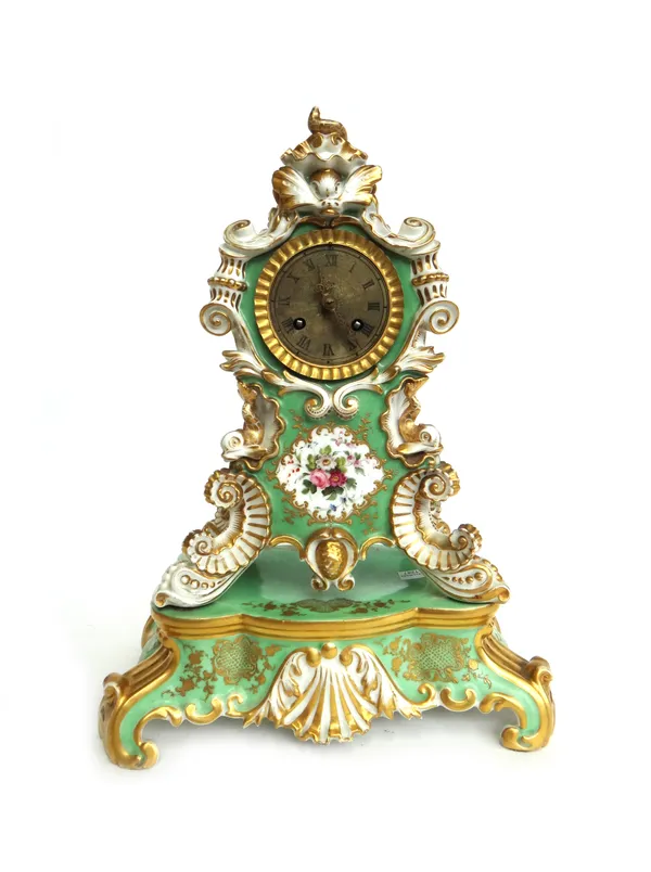 A French porcelain mantel clock, late 19th century, in the manner of Jacob Petit, moulded with shells, dolphins and flowers against a gilt green groun