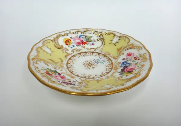 A Minton porcelain part tea service, circa 1830, gilt foliate decorated against a yellow ground, comprising; two twin handled square cake plates, 24.5