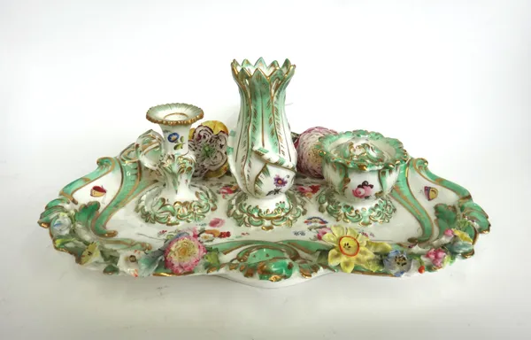 An English porcelain desk set, 19th century, with loop handle and a shaped, floral encrusted tray, with inkwell, night light and quill holder, 29.5cm
