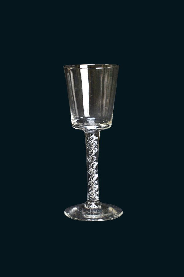 A glass wine goblet, circa 1750, the bucket bowl raised on a double mercury twist stem and plain foot, 17.3cm high.  Illustrated