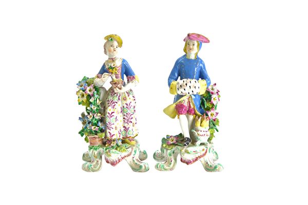 A pair of unusual Bow porcelain figures, circa 1765, representing Spring and Winter from the Seasons, Spring as a girl standing beside flowers and hol