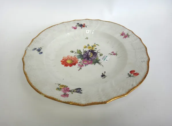 A Copenhagen part dinner service, early 20th century, hand painted with still life flowers within a relief moulded and shaped basket weave border, com