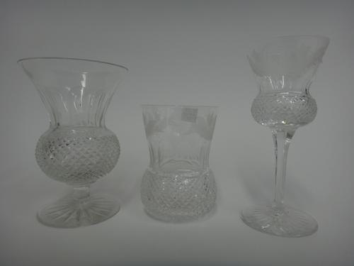 An Edinburgh part suite of stemware, 'Thistle' pattern, comprising; two decanters and stoppers, one smaller, five white wine glasses, five red wine gl
