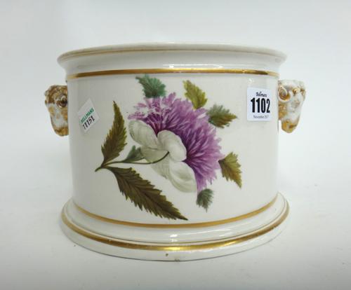 A Derby bough pot, early 19th century, foliate decorated and flanked by gilt rams head masks against a demi lune body, pseudo Chinese mark to base, 24