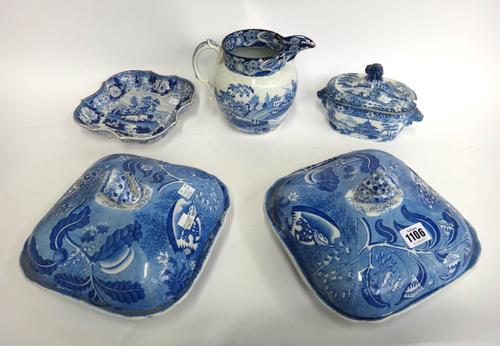 A pair of blue and white pottery tureens and covers, 19th century, with shell finial over a shell and foliate decorated cover, the base detailed with