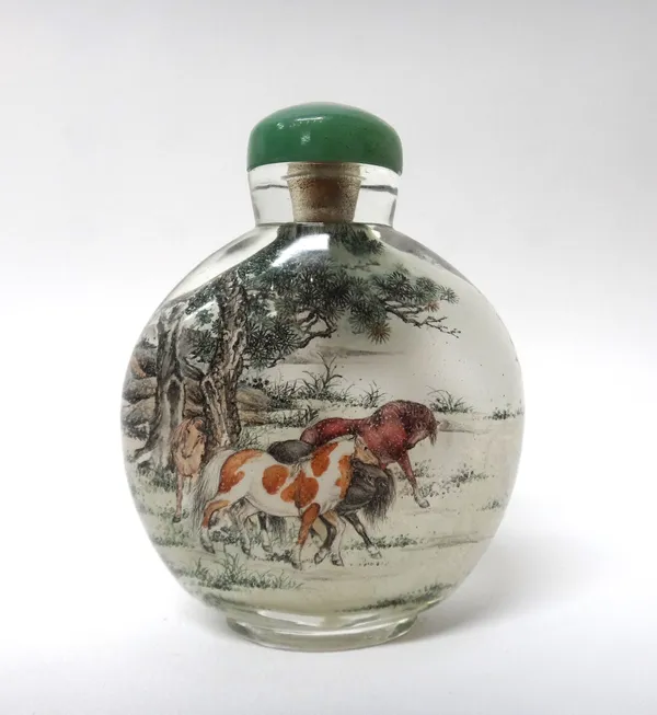 A Chinese inside painted glass snuff bottle, 20th century, painted with eight horses in a landscape, signed, 7cm. high.