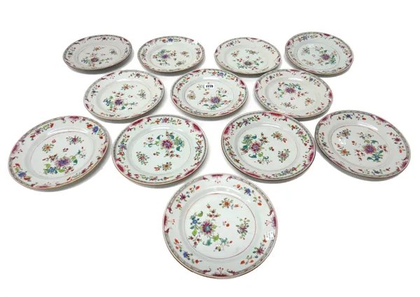 A set of twelve Chinese famille-rose plates, Qianlong, each painted with scattered flowers, (a.f), 22.5cm. diameter.