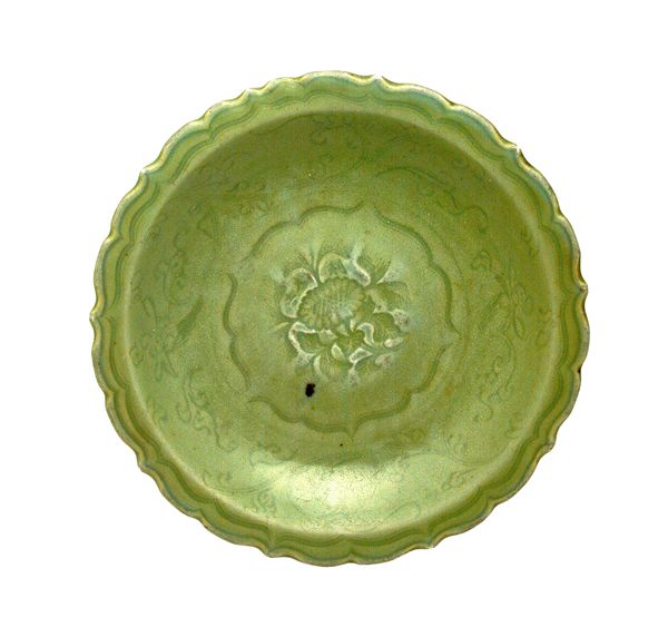 A Longquan celadon dish, Ming dynasty, 14th/15th century, stamped in the centre with  flower spray and four characters, with floral scrolls to the wel