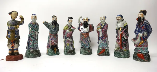 Seven Chinese famille-rose Immortals, 20th century, each standing with attribute on a green wave base, (a.f), each approx. 24cm.high; and a painted te