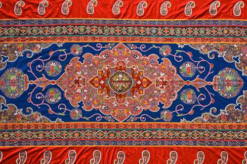 A large embroidered hanging, Rescht, Persia, 20th century, the main deep blue field with central lobed medallion with polychrome floral design, simila