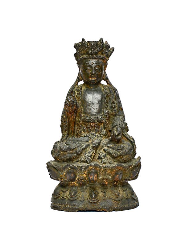 A Chinese bronze figure of Guanyin, probably Ming dynasty, 17th century, the goddess seated in meditation on a lotus base, traces of gilding, 17cm. hi