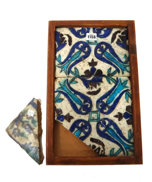 A Damascus pottery tile panel, 16th/17th century, comprising of two tiles,  painted in blue , black and manganese with a composition of tulips, (a.f),