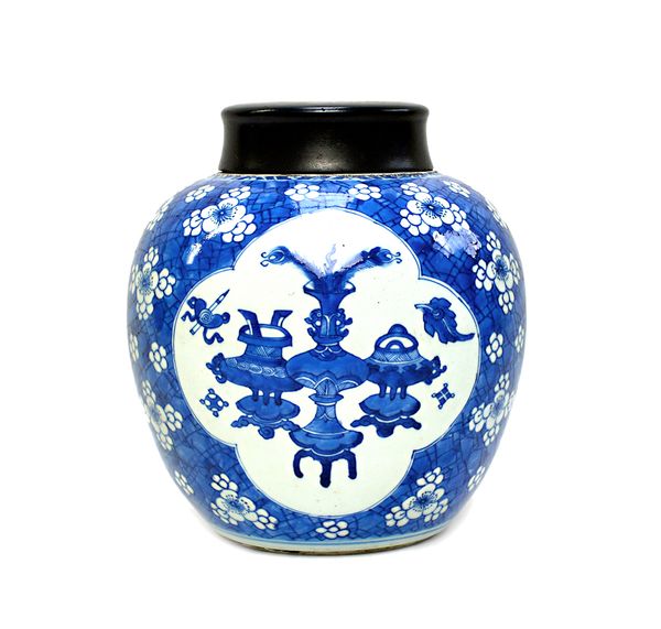 A Chinese blue and white ginger jar, Kangxi, painted with three barbed panels enclosing Precious Objects against a `cracked ice' ground, 22cm. high, w
