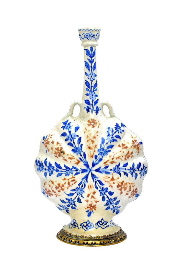 A Persian pottery two-handled flask, probably Safavid, 17th century, the lobed flattened discoidal body painted with panels of radiating underglaze-bl